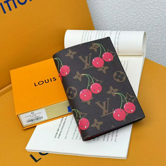 Cherry print monogram passport cover styled with feminine travel essentials
