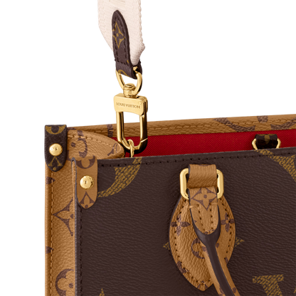 Close-up of a brown leather handbag with gold hardware and monogram pattern.